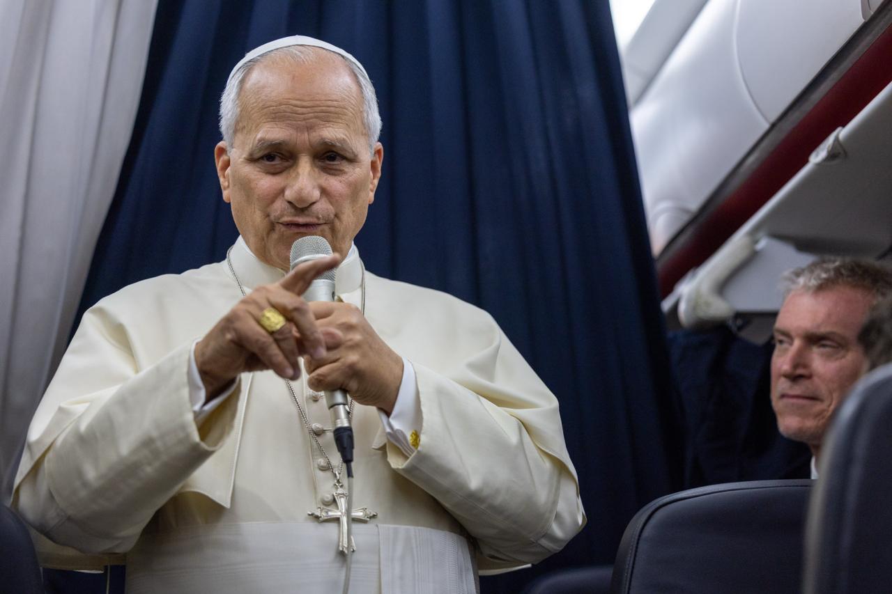 Pope Leo says he is not ‘in panic mode’ over AI dangers – #Catholic – ABOARD THE PAPAL FLIGHT — Pope Leo XIV said he takes seriously the warnings raised by tech experts about the dangers of AI — including risks to humanity — but he is not panicking over dire predictions.“If someone were to ask me, am I in panic mode, no I’m not, I sleep at night. I do think the concerns raised by many experts in AI should be taken seriously,” the pope told reporters accompanying him on his flight to Rome from Metz, France, Sept. 28.“I don’t think that is fake news, as some have said, to try and cause … financial or some other kind of benefit,” he added.A former safety researcher at the AI company Anthropic warned earlier this month that he believes the technology’s rapid advancement could mean there’s a more than 10% chance that AI could “could kill all humans” within a decade.Anthropic CEO Dario Amodei responded by calling on the AI industry to slow down the pace of advanced model development to address risks, and other industry leaders publicly supported his call.That drew criticism of Amodei from President Donald Trump, who dismissed dire scenarios and said restrictions on AI development in the U.S. would benefit China. The two men dined together on Sunday in an apparent attempt to address their differences.The pope’s encyclical on AI, Magnifica Humanitas, published just four months ago, included a broad call for regulation of the technology.In recent months, concerns have grown over AI’s risks of creating advanced cyberattacks and autonomous agents that will get past human control and threaten humanity.Pope Leo told journalists on Monday that the Vatican has organized its own commission on AI, both to coordinate its own use of the technology and to “continue to promote dialogue, study, investigation to find ways to make sure that AI doesn’t get to a point where it destroys humanity.”“But we have to keep working. We can’t just sit back and pretend nothing is going to happen,” he said.Leo was returning to Rome after a four-day trip to France.In response to another reporter’s question, the pope said it was vital for the Church to proclaim Catholic social doctrine even on controversial matters such as end-of-life issues and political extremism.Asked if he had “crossed a line” in France, where there is a strict separation of church and state, by speaking against the recent legalization there of euthanasia and assisted suicide, he said: “I didn’t cross it,” because “we’re not entering into politics; we’re applying the Gospel to people’s lives.”“The defense of life is something that, as you all know, the Church teaches, believes very deeply,” the pope said.“Being in a place especially like Lourdes, where people are searching for something much deeper and understanding that their lives, even in the midst of sickness or disability or pain of different kinds, that their life has meaning, the Church, because of Jesus himself, wants to be close to those people and to affirm the values that that life itself I think holds for all of us,” the pope said.Asked whether he thought clerical sexual abuse was “systemic” in the Church, Leo said he preferred “to express it in a different way.”He said some organizations within the Church have, at times, “as a system, been abusive.”“But I think itʼs important to make the distinction. Sexual abuse is first and foremost a human problem. … When it happens within the Church it actually has another whole dimension added to it, because peopleʼs lives of faith are deeply wounded and sometimes even destroyed,” the pontiff said.“The Church, in certain ways, has been seen as being responsible, but in the same way, the Church, I think, is an important part of helping [victims] to find healing.”