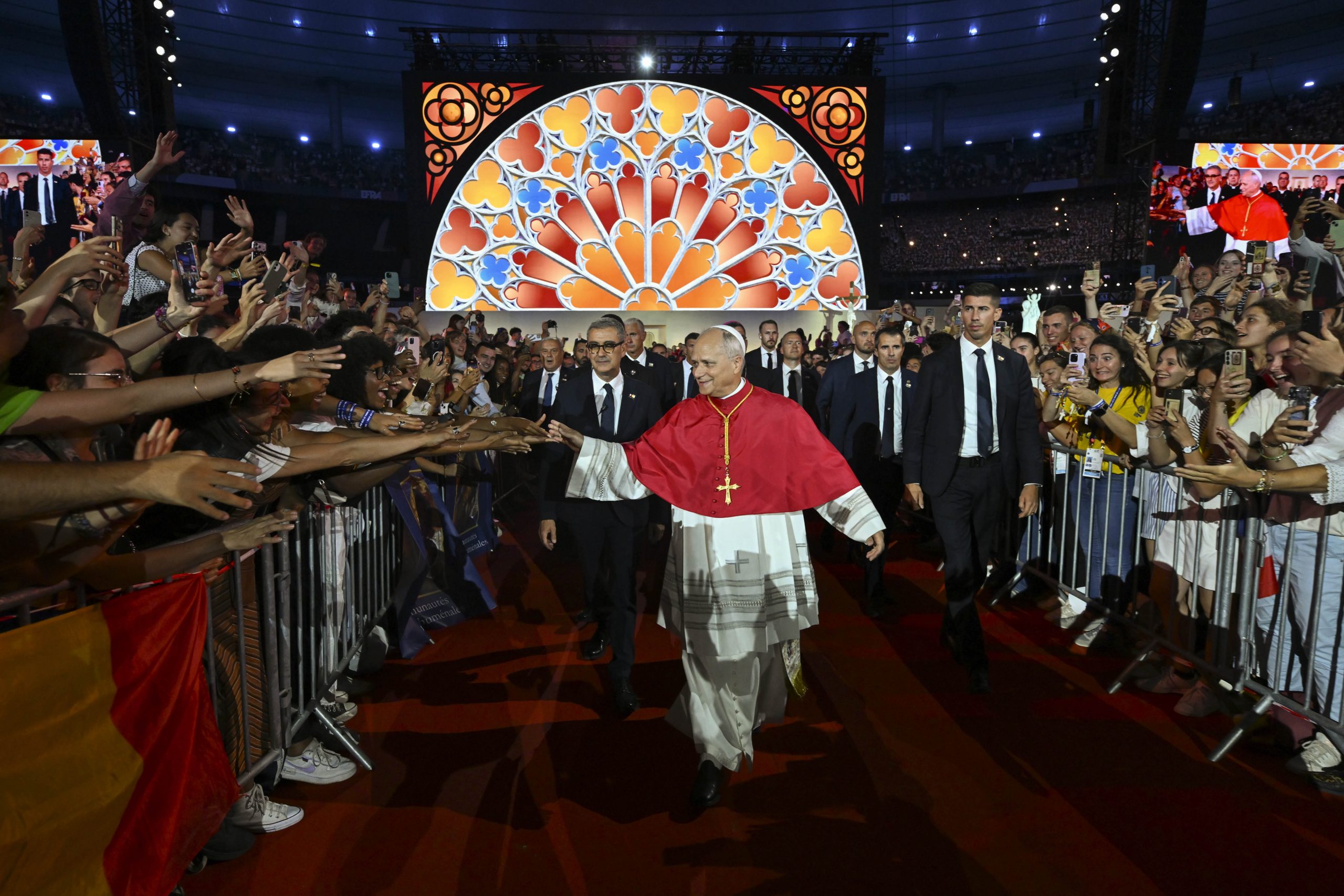 Thousands of young French Catholics converge on soccer stadium for prayer with Pope Leo #Catholic SAINT-DENIS, France — At least 80,000 young Catholics flocked to France’s national soccer stadium north of Paris on Friday night to pray with Pope Leo XIV and to hear his message for the Church.Whether they were lifting their arms in praise-and-worship or silently venerating the relics of saints and the Holy Tunic of Christ, the entire Stade de France was united in prayer before Leo’s arrival and throughout an hour and a half-long program.People from working-class suburbs stood alongside families from the more traditional Catholic milieu associated with the city of Versailles. In the lines outside the stadium, Breton and Vendéan flags — from regions with strong Catholic histories — stood alongside groups with a more popular, charismatic style.One young woman, 29-year-old Romance Bono, wiped tears from her eyes as the pope entered the stadium to deafening cheers.“It brought tears to my eyes because it’s such an emotional moment,” she told EWTN News. “Seeing all these young people cheering for the pope like a rock star, that is the strength of the Church, and it is the future of the Church here. It was very moving.”
 
 Young people greet Pope Leo XIV at a prayer vigil at Stade de France on Sept. 25, 2026 in Saint-Denis, France. | Credit: Vatican Media
 
 Soon after Pope Leoʼs arrival at the stadium, hundreds of young French Catholics staged an artistic performance depicting French saints and the history of the Church in France, including the use of live horses, and culminating in fireworks launched above the stadium.One 28-year-old volunteer, Jacques-Henri de Livron, told EWTN News that as soon as he heard the pope was coming to France, he decided to take a day off work to see him. He was so afraid of missing the events that he volunteered to make sure he could be in attendance. De Livron grew up in a Catholic environment, but returned to the faith in his twenties after painful deaths among his siblings and close friends. Those experiences, he said, made him recognize its value anew.“Christianity is really the religion of the human person,” he said. “In this age of narcissism, it helps us get out of ourselves, turn toward others and care about them instead of thinking only about ourselves. People often call it a religion of the book, or a religion of revelation. But it’s much more than that. It’s the religion of the human person.”De Livron also made a point of sharing his surname, which is unusual in France, where anticlerical culture is widespread and religious people usually ask to be identified in press reports only by their first names in order to avoid trouble at work. “I want to be part of a generation that stops being afraid to testify, that gives its name, and isn’t afraid of anything,” he said.Pierre-Alain Belaube, 34, described the effort to arrive hours early after a long day at work, and to fight the crowds to enter into the packed stadium, as “200% worth it. It’s a privilege to be here.”Belaube described himself as a formerly lukewarm Catholic, whose life was transformed when he read the autobiography of St. Ignatius of Loyola.“I have the hope that many more young people will open their hearts to God and let him change their life,” he said. “I think that such an event can be, for many, the first milestone of a life-changing experience. I hope we will inspire many more young people to get to know Jesus.”Thibault, a religious brother who preferred not to give his last name because he did not have permission from his superiors to speak with reporters, accompanied 400 members from the youth movement of his religious community, the Missionaries of Divine Mercy, to the event.He told EWTN News that it is very moving to be surrounded by young people “wanting to say, ‘Here I am, I’m Catholic and I’m proud to show it.’”The young religious, who is also studying for the priesthood, said he hopes Leo’s visit to France “will contribute to the missionary awakening that needs to happen in France.”While the primarily secular country is seeing a surprising surge in baptisms, he said he thinks “Catholics still find it difficult to go out and meet people, to be missionaries in their daily lives.”“I think this could become a significant moment in the life of the Church in France.”In his message during the prayer, which included religious hymns and a Litany of Saints, Leo invited young people to shun evil and strive for good.“God is the Lord of history, and no matter what happens, he guides its course toward salvation. In Christ, every evil comes to an end, precisely because that end becomes the beginning of a new and eternal life,” he said.“The work well done, the work that is good, is the redemption that Jesus accomplishes for us,” Leo said. “Through his struggle against sin and death, Christ’s victory sets us free. He saves us from all evil and invites us to all that is good.”The pontiff also answered the questions of two young French people as part of the evening’s program.Chloé, 25, talked about her involvement in her parish and in a group of young Catholics “eager to live out and share their faith with others.” But she lamented that society “is founded on different principles” and sometimes has “no regard for the question of God.”Pope Leo responded that, “It is true, as you say, that the society in which we live seems indifferent to God. But the Lord is not indifferent to us! This is what matters, and what always gives us hope.”Chloé, who is from Saint-Denis, described the vitality of Catholic life there. Saint-Denis is often described as a quartier sensible (“a vulnerable neighborhood”). Her testimony echoed what EWTN News heard from local Catholics in the crowd, including people from immigrant backgrounds, about the life of the Church in their neighborhoods that have a strong Muslim presence.A young man from Burgundy, named François, also addressed the pope and asked him how young people can discern how the Lord is calling them to serve.Leo’s advice to young people was to keep their hearts open to the suffering of their peers, to follow Jesus, and to draw inspiration from the examples of the saints.“Even in the face of persecution, these brothers and sisters of ours opened paths of peace. Look to those priests who were passionate about Christ, such as St. Eugene de Mazenod and St. John Mary Vianney. Look to the mystical beauty of St. Thérèse of the Child Jesus; the fervor in charity and mission of Blessed Pauline Jaricot; and the courage of the 50 martyrs of the apostolate who served their brothers and sisters even to the point of sacrificing their own lives during the Second World War,” he said.“These saints changed the course of history by leading many people from hardship to hope, since they first changed their own hearts, transforming them in the light of faith.”The youth vigil was the pope’s last event on a packed first day in France. The Sept. 25-28 journey will also take him to Lourdes and Metz.