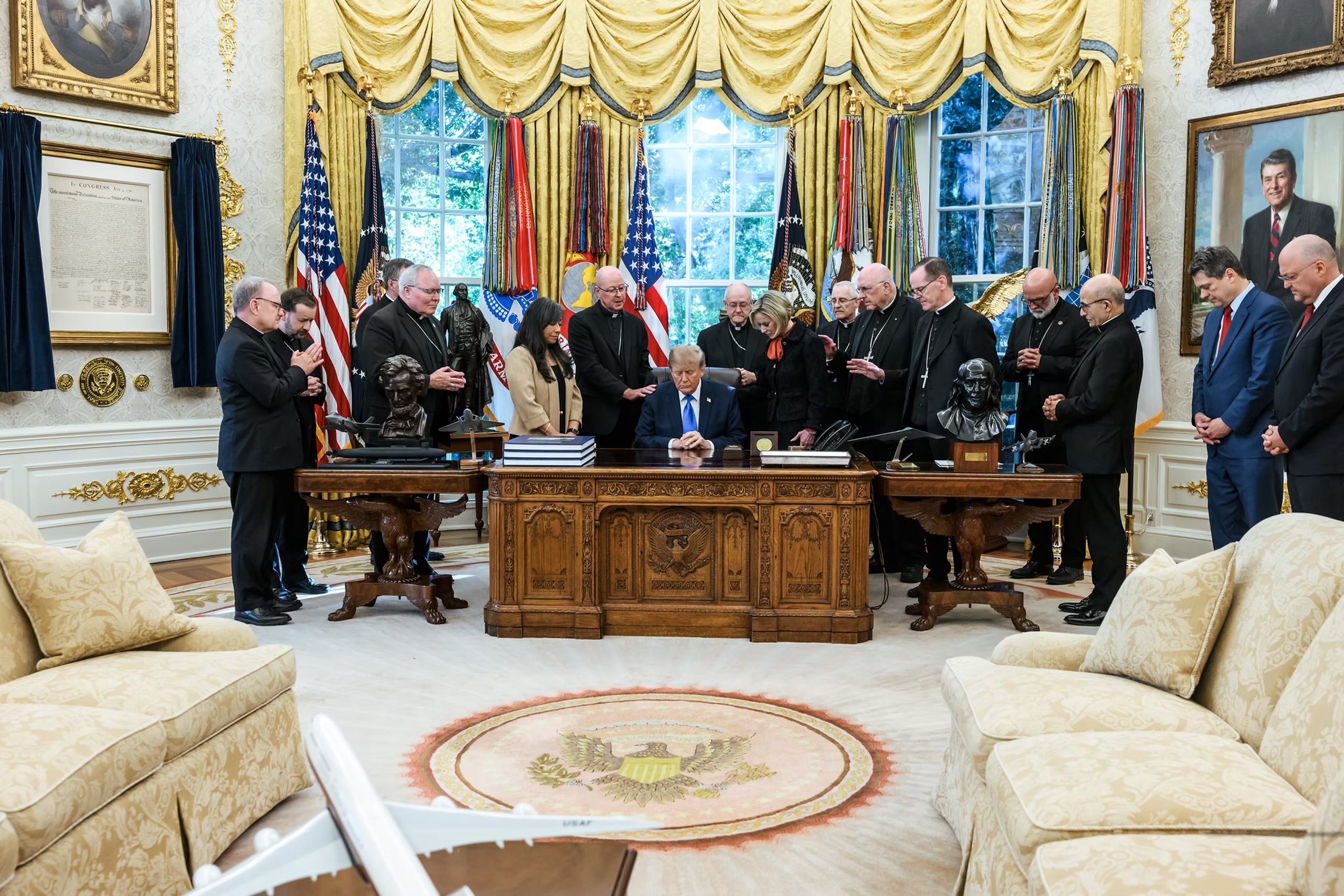 Bishop Joensen says Trump meeting ‘exploited’ for politics, while others clarify backstory – #Catholic – A second bishop is expressing regret over a meeting with President Donald Trump at the White House last week and complained that it has been “exploited” for political gain, while others who attended are clarifying the reasons they went.On Oct. 22, the White House posted a video that showed Denver Archbishop James Golka leading a prayer with Trump, surrounded by about a dozen other bishops, who stood beside the president’s spiritual advisor Paula White-Cain and White House Faith Office Director Jennifer Korn.The video was shared by Margo Martin, a White House communications advisor, with no news release to accompany it, nor any description of what was discussed. Golka shared the video on archdiocesan social media and clarified it was not a political endorsement.Bishops who attended the meeting and the prayer have stated they were invited by the White House Faith Office to discuss issues of importance to Catholics: the right to life, the dignity of migrants, religious liberty, and school choice. Several have echoed Golka, emphasizing the meeting and prayer was not a political endorsement, while two have expressed regret for going.On Oct. 25, Milwaukee Archbishop Jeffrey Grob issued a “public apology” for any confusion the video caused, saying he did not know it would be shared publicly and it was not meant to be an endorsement of the president.A second bishop — Des Moines Bishop William Joensen — also emphasized that it was not an endorsement and conveyed regret over the video being used for political purposes.The U.S. Conference of Catholic Bishops (USCCB) had no role in the meeting.‘Exploited’ for politicsOn Oct. 24, two days after the meeting, Joensen issued a statement saying “I would have done well to be more mindful Jesus’ admonition [in the Gospel of Matthew]: ‘Behold, I am sending you like sheep in the midst of wolves; so be shrewd as serpents and simple as doves.’”“I wish I had been more shrewd and less simple, like those who exploited our meeting for partisan political purposes,” Joensen said. “I pray I am more prudent and wise going forward, even as I remain resolute in my openness to engaging and praying for political leaders at all levels.”Joensen did not say who he was accusing of exploiting the meeting and a spokesperson for the diocese did not respond to a request for clarification from EWTN News.In his statement, Joensen said he was invited by officials associated with the Faith Office to talk about a variety of issues: immigration, the exploitation of the poor, visas for international clergy, advancement of a culture of life as an alternative to abortion, and support for private education.“There was also a concluding opportunity to pray for and with our president, that God would guide his heart and impel him to lead in a way consistent with the dignity of his office,” he said.Joensen said “there are many things” linked to the administration “at odds with our Catholic faith.” Yet, he said he attended to “have a conversation” and was informed officials “would be interested in hearing our perspective.”When reached by EWTN News for comment, White House spokeswoman Taylor Rogers said in a statement, “there has never been a greater president for Catholic Americans than President Trump, and his strong record proves it.”“He stopped the weaponization of the federal government against Christians, proudly defended and expanded our religious rights, pardoned pro-life activists, stopped the chemical mutilation of our nation’s children, and protected parents’ rights,” Rogers said, but did not respond to a follow up request for a response to the comments made by Joensen and Grob.Explanations by other bishops In addition to Golka, Grob, and Joensen, a few other bishops have issued statements about the reasons they met and prayed with Trump in the Oval Office and what they talked about with administration officials.The Diocese of Rapid City, South Dakota provided a statement to EWTN News on behalf of Bishop Scott Bullock, which said the delegation discussed Catholic priorities: abortion, school choice, and the ethical implications of in vitro fertilization (IVF).According to the diocesan statement, the bishops’ prayer over Trump is not an “endorsement,” but is rather based in Scripture and following the instruction of St. Paul, who said “supplications, prayers, petitions and thanksgivings be offered for everyone, for kings and for all in authority, that we may lead a quiet and tranquil life in all devotion and dignity.”“We went there and we prayed, and we asked the Lord to instill our leaders with wisdom and also to help them remain humble,” Bullock said.A spokesperson for Diocese of Gallup, New Mexico’s Bishop James Wall told EWTN News that “Bishop Wall does want to express that he would accept a meeting with any politician, if invited, to discuss important church matters, regardless of the time of year and the political party, and that he offers prayers for all who hold political office, that they lead with integrity and not division.” The office of Archbishop Emeritus Joseph Naumann, who led the Archdiocese of Kansas City before retirement, also released a statement indicating that during the meeting the prelate voiced concerns about chemical abortion and IVF, while advocating for pro-life reproductive health care. He also discussed religious liberty, immigration, school choice, and protecting children from pornography.According to the statement, Trump expressed gratitude to the bishops “for prayers asking God to bless and guide the president, his staff and the nation.” The archbishop’s office emphasized this was not an endorsement and that the bishops “were assured that no photographs would be made public.”“They came to have a discussion on important policy matters,” the statement indicated. “As Catholic bishops, they pray with everyone, but do not endorse candidates or political parties.”The following bishops also attended the meeting, according to the White House: Bishop Edward Burns of the Diocese of Dallas, Bishop Steven Raica of the Diocese of Birmingham, Bishop Thomas Hennen of the Diocese of Baker, Bishop Michael Barber of the Diocese of Oakland, Bishop Francis Kalabat of the Chaldean Catholic Church, and Bishop Elias Zaidan of the Maronite Catholic Church.Bishop of Palm Beach Jesús Rodríguez — who did not attend the meeting — opined on the matter on X, saying any action perceived as a political endorsement by a member of the Church hierarchy “must not be construed as representing the official position of the Catholic Church.”The meeting was also attended by Mario Enzler of the Heritage Foundation, though the Heritage Foundation has stated it did not organize it.