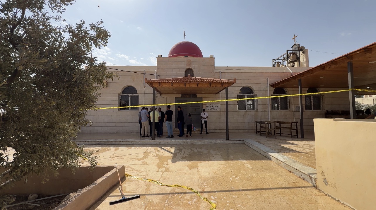 Jordan church attack death toll rises to 9 as Christian leaders call for unity – #Catholic – The death toll from the armed attack on St. George Greek Orthodox Church in Hamoud, in southern Jordan’s Karak governorate, has risen to nine, with others wounded. The attack took place during a funeral Friday, and security authorities are continuing their investigation and search for the perpetrators.According to authorities, three gunmen arrived at the church in a blue pickup truck. One wore a mask and carried a Kalashnikov rifle, while the other two had their faces uncovered and carried handguns. The shooting began near the church’s main entrance, where mourners had gathered.Al Jazeera’s Arabic-language website reported that the attackers carried substantial quantities of ammunition and changed their weapons’ magazines several times during the assault. They also fired again at some people after they had fallen to the ground. According to the same report, all those killed were near the church entrance when the shooting began.Jordanian Interior Minister Mazen al-Faraya described the assault as a terrorist attack carried out by an extremist group. Public Security Director Maj. Gen. Obeidallah al-Maaytah said authorities were continuing to gather information and investigate to identify the perpetrators, arrest them, and bring them to justice.As of Saturday morning, Jordanian authorities had not officially linked the attackers to a specific organization or announced any arrests. Media reports, citing Jordanian government and security sources, said the perpetrators espoused a takfiri ideology, an extremist outlook that declares other Muslims to be unbelievers. A public prosecutor ordered a ban on publishing details of the investigation as authorities continued their search.King Abdullah II pledged that the perpetrators would face the harshest penalties.“Those who imagined that treacherous bullets could divide Jordanians have been thwarted by our resilience and unity,” he said, emphasizing Jordanians’ shared homeland and solidarity.In their response, the patriarchs and heads of churches in Jerusalem described the targeting of mourners at prayer as “a grave crime against God and humanity.” They expressed solidarity with Greek Orthodox Patriarch Theophilos III of Jerusalem, the Greek Orthodox Archdiocese in Jordan, and the victims’ families.They called on all churches in the region to ring their bells at noon Saturday Jordanian time and to pray for the victims and the recovery of the wounded. They stressed that the attack would not succeed in undermining the unity and cohesion of Jordanian society.The Latin Patriarchate of Jerusalem said the attack violated the sanctity of places of worship and the right to life and to worship freely and with dignity. It described Jordan’s national unity as “a safeguard against terrorism and extremism,” emphasizing that the country’s Muslims and Christians form one family bound by a shared history and destiny.The Greek Orthodox Patriarchate of Jerusalem, under whose jurisdiction the targeted church falls, affirmed that the attack would not undermine the Christian presence or Christians’ ties to their homeland.“We are the children of this land, its living roots, and partners in its history, present, and future. We will remain here as witnesses to the faith, however great the challenges,” the patriarchate said.The Jordan Council of Churches said the attack on the church and the mourners targeted social peace and coexistence. It emphasized solidarity among all communities in Jordan and rejected attempts to sow religious division.The statements from Jordan were accompanied by condemnations from churches across the region, including the Middle East Council of Churches and several churches and patriarchates. Their responses emphasized the protection of places of worship, the need to confront extremist rhetoric and hate speech, and the fact that Christians are an integral part of the region’s societies, with deep roots in their homelands.Church bells rang across Jordan and Palestine at noon Saturday in remembrance of those killed and in solidarity with their families and the wounded, answering the appeal of the patriarchs and heads of churches in Jerusalem.This story was first published by ACI MENA, the Arabic-language sister service of EWTN News. It has been translated and adapted by EWTN News English.