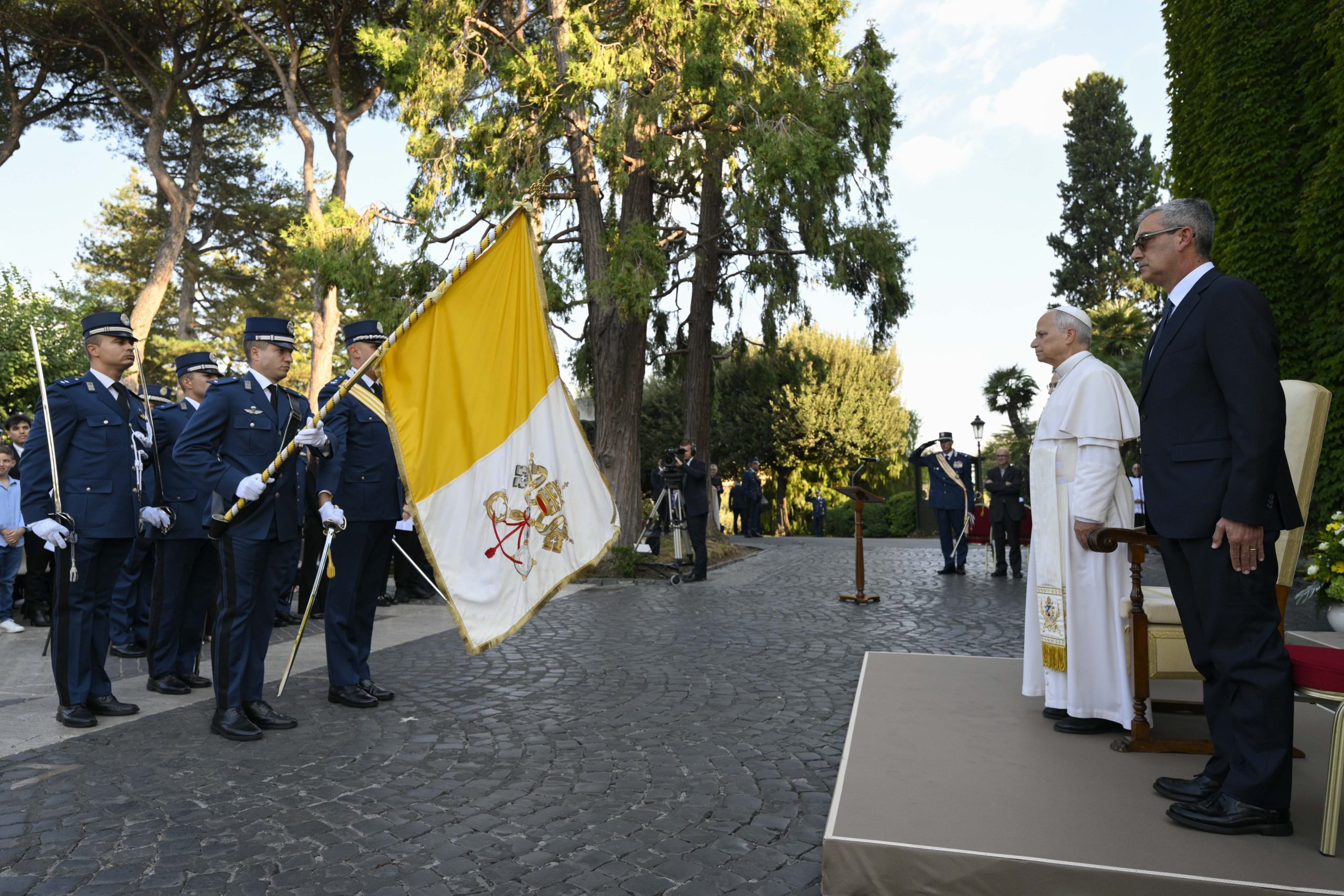 Pope Leo urges Vatican police to guard their hearts as they protect others #Catholic Pope Leo XIV urged members of the Vatican Gendarmerie on Oct. 3 to nurture their faith as they protect others, telling them that their service requires hearts guarded by the Lord.The pope celebrated Mass at the Lourdes Grotto in the Vatican Gardens in honor of the force’s patron, St. Michael the Archangel.He described the gendarmes’ work as “a way of being laborers in the Lord’s vineyard,” stressing that their responsibilities extend beyond safeguarding buildings, grounds, and entrances to caring for people.“One quality that stands out when we meet you is precisely this care: It is beautiful to see how you regard others not as problems to be solved but as people to be respected and protected,” he said.Reflecting on the parable of the wicked tenants in Matthew 21:33-43, the pope said the gendarmes should understand that “what we receive is a responsibility to be safeguarded with humility and dedication, to be carried out with discretion and a sense of duty.”“You know well that authority, in the light of the Gospel, is expressed above all in the ability to protect, listen, and accompany, with balance, firmness, and respect,” he added.Just as the vineyard owner’s son stands at the center of the parable, Leo urged the gendarmes to place Jesus at the center of their lives.“Before being gendarmes, you are men called to follow him. From him we learn strength that knows how to become gentleness, vigilance born of trust, authority that walks alongside humility, and the courage to intervene with a merciful heart,” he said.The pope also reflected on the second reading, from St. Paul’s Letter to the Philippians, which urges believers to bring their needs to God in prayer rather than give in to anxiety.The gendarmes’ work, he said, would bring “quiet days and difficult days,” moments requiring quick decisions, and situations that cause fatigue and worry.But prayer offers a way to bear those burdens.“A gendarme does not carry everything alone: He prays, knows how to entrust himself to God, and knows how to find again in God the peace that allows him to act with clarity and a serene heart,” Leo said.Those who protect others need hearts and minds “formed in goodness,” he said, because they “must first safeguard within themselves truth, justice, goodness, and respect. Protecting others requires a heart guarded by the Lord.”“Your work certainly requires you to be vigilant, but today’s word invites you to something even deeper: to watch carefully over yourselves as well,” the pope added.He urged the gendarmes to guard their hearts against becoming hardened, keeping them “always docile to God and attentive to others.”He also called on them to safeguard their consciences and their bonds of fraternity. A group becomes a community, he said, when “its members care for one another and learn to walk together, supporting one another with simplicity and love.”Leo concluded by thanking the gendarmes’ families for the sacrifices that make their service possible.“This year, too, I conclude with a thought of affection and gratitude for your families. To parents, wives, children, and fiancées: Thank you! You know the sacrifices, the absences, the schedules, the worries, and also the burden of a service that is not always seen,” he said.This story was first published by ACI Prensa, the Spanish-language sister service of EWTN News. It has been translated and adapted by EWTN News English. Pope Leo urges Vatican police to guard their hearts as they protect others #Catholic Pope Leo XIV urged members of the Vatican Gendarmerie on Oct. 3 to nurture their faith as they protect others, telling them that their service requires hearts guarded by the Lord.The pope celebrated Mass at the Lourdes Grotto in the Vatican Gardens in honor of the force’s patron, St. Michael the Archangel.He described the gendarmes’ work as “a way of being laborers in the Lord’s vineyard,” stressing that their responsibilities extend beyond safeguarding buildings, grounds, and entrances to caring for people.“One quality that stands out when we meet you is precisely this care: It is beautiful to see how you regard others not as problems to be solved but as people to be respected and protected,” he said.Reflecting on the parable of the wicked tenants in Matthew 21:33-43, the pope said the gendarmes should understand that “what we receive is a responsibility to be safeguarded with humility and dedication, to be carried out with discretion and a sense of duty.”“You know well that authority, in the light of the Gospel, is expressed above all in the ability to protect, listen, and accompany, with balance, firmness, and respect,” he added.Just as the vineyard owner’s son stands at the center of the parable, Leo urged the gendarmes to place Jesus at the center of their lives.“Before being gendarmes, you are men called to follow him. From him we learn strength that knows how to become gentleness, vigilance born of trust, authority that walks alongside humility, and the courage to intervene with a merciful heart,” he said.The pope also reflected on the second reading, from St. Paul’s Letter to the Philippians, which urges believers to bring their needs to God in prayer rather than give in to anxiety.The gendarmes’ work, he said, would bring “quiet days and difficult days,” moments requiring quick decisions, and situations that cause fatigue and worry.But prayer offers a way to bear those burdens.“A gendarme does not carry everything alone: He prays, knows how to entrust himself to God, and knows how to find again in God the peace that allows him to act with clarity and a serene heart,” Leo said.Those who protect others need hearts and minds “formed in goodness,” he said, because they “must first safeguard within themselves truth, justice, goodness, and respect. Protecting others requires a heart guarded by the Lord.”“Your work certainly requires you to be vigilant, but today’s word invites you to something even deeper: to watch carefully over yourselves as well,” the pope added.He urged the gendarmes to guard their hearts against becoming hardened, keeping them “always docile to God and attentive to others.”He also called on them to safeguard their consciences and their bonds of fraternity. A group becomes a community, he said, when “its members care for one another and learn to walk together, supporting one another with simplicity and love.”Leo concluded by thanking the gendarmes’ families for the sacrifices that make their service possible.“This year, too, I conclude with a thought of affection and gratitude for your families. To parents, wives, children, and fiancées: Thank you! You know the sacrifices, the absences, the schedules, the worries, and also the burden of a service that is not always seen,” he said.This story was first published by ACI Prensa, the Spanish-language sister service of EWTN News. It has been translated and adapted by EWTN News English.