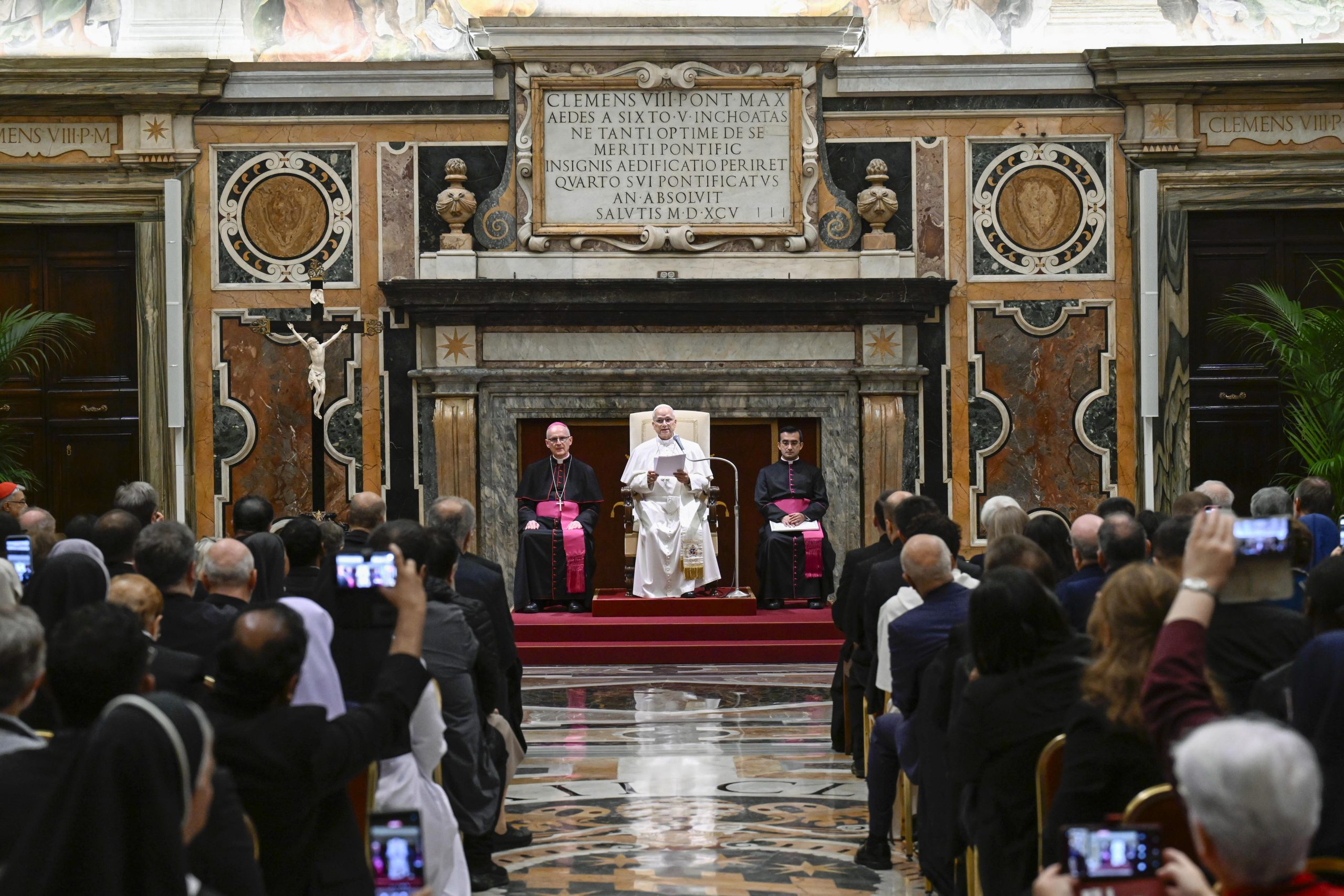 Pope Leo XIV: The world is poorer without saints – #Catholic – Pope Leo XIV, in his first private audience since undergoing surgery on Oct. 13, said the history of the world is inseparable from the history of the saints.“The history of the world without saints would be immeasurably poorer; that is, less human,” Leo said in his address.The pontiff met on Wednesday with participants of the “Holiness in History” conference, held at the Patristic Institute Augustinianum center in Rome from Oct. 19–21. Organized by the Dicastery for the Causes of Saints, the conference explored the role of historical research in determining whether to declare someone a saint. Rigor in canonization causesIn his remarks, Leo referenced Pope Pius XI, who established the dicastery’s historical section in 1930, and emphasized that recent causes for canonization must continue to be carefully evaluated against historical evidence of one’s holiness.
 
 Pope Leo XIV delivers remarks during a private audience at the Apostolic Palace in the Vatican with participants in the “Holiness in History” conference on Oct. 21, 2026. | Credit: Vatican Media
 
 “The treatment of ‘recent causes’ likewise cannot dispense with a serious and rigorous examination of all the material collected,” Pope Leo said. “Causes of saints make use of the tools proper to the study of history, even though their aim is not to produce historiography, but rather to bring to light the exemplary nature, spirituality, and reputation for holiness of those proposed for the altars.”Saints must be understood in contextLeo also explained the importance of placing canonized saints in the context in which they lived, eliminating stereotypes and misunderstandings.“As the ages pass, even the profile of saints may undergo development: not to follow the stereotypes of the moment, but to interpret a particular experience through the categories of the Gospel lived out,” Leo said. “For this reason, placing the witness of a saint within the context in which he or she lived is very important. The people of God seek models for living in the present, intercessors who help members of the Church face today’s challenges and recognize their opportunities.”