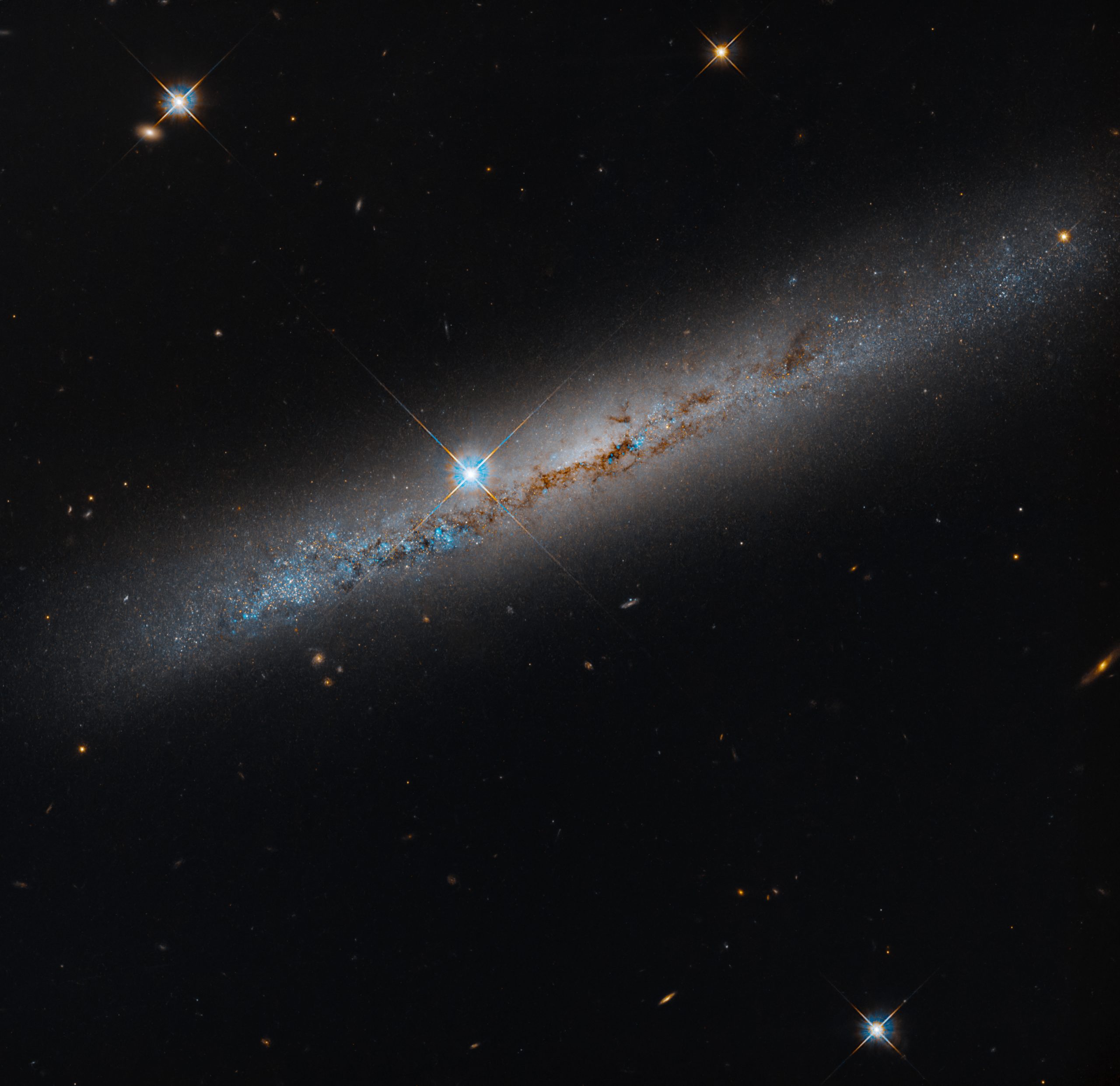 Spiral’s Edge – This NASA Hubble Space Telescope image features the edge-on, intermediate spiral galaxy NGC 1827, located roughly 37 million light-years away in the constellation Columba, the Dove. Spiral’s Edge – This NASA Hubble Space Telescope image features the edge-on, intermediate spiral galaxy NGC 1827, located roughly 37 million light-years away in the constellation Columba, the Dove.