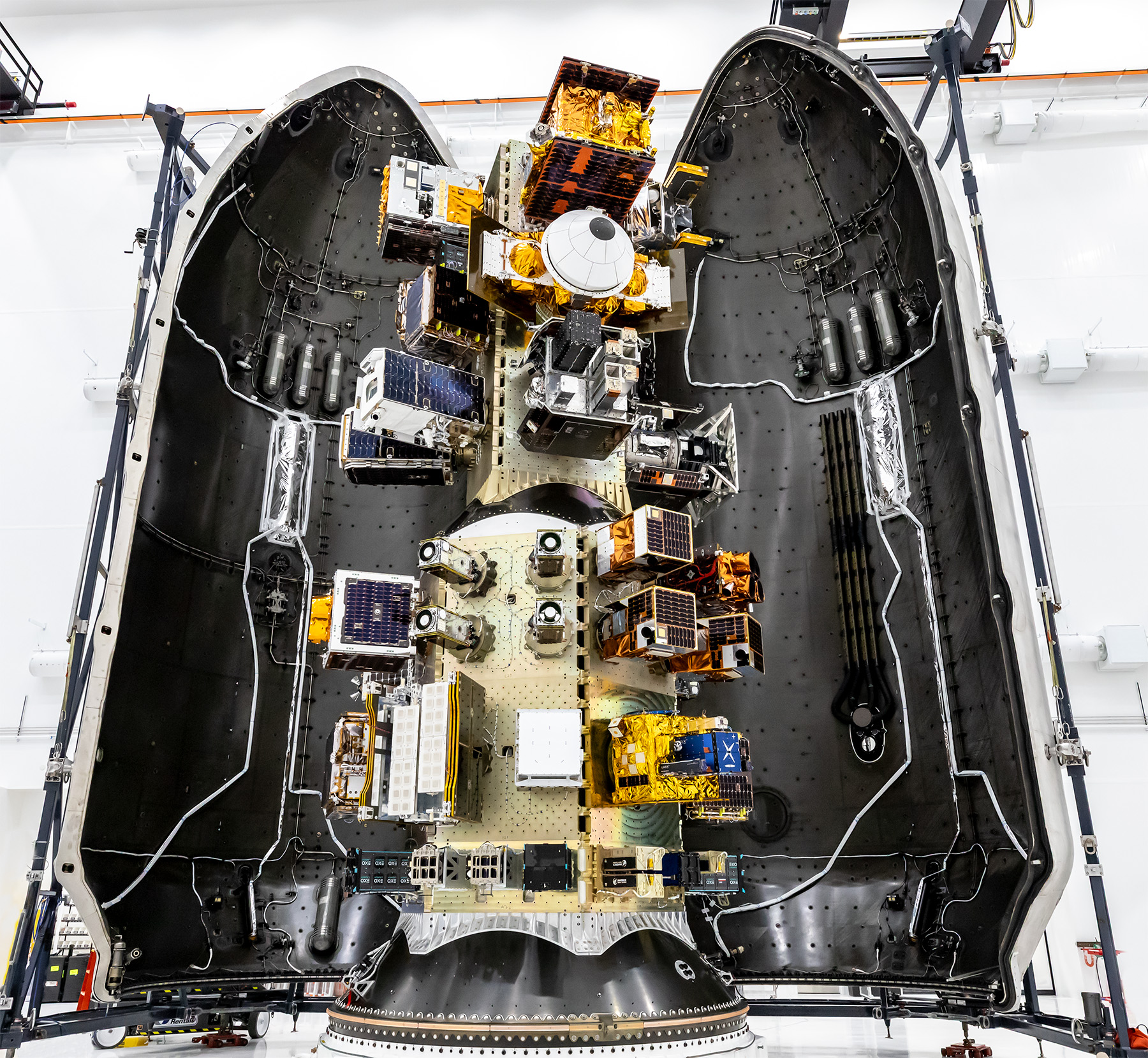 Transporter-18 SmallSats Encapsulation – Three NASA-supported small spacecraft, shown along with many commercial payloads, before being encapsulated in a SpaceX Falcon 9. The rocket launched the payloads into low-Earth orbit at 11:32 a.m. PDT Thursday, Oct. 1, 2026, as part of the company’s Transporter-18 mission from Space Launch Complex 4 East at Vandenberg Space Force Base in California.